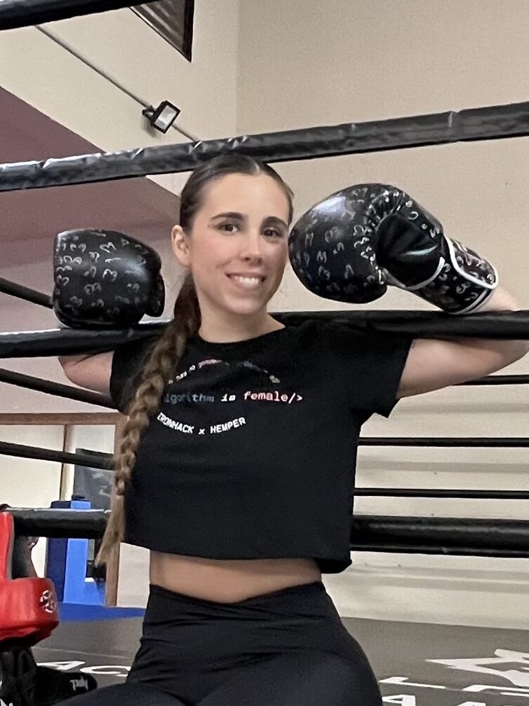 the founder of Gladiatrix Barbara sitting in the gym with black boxing gloves